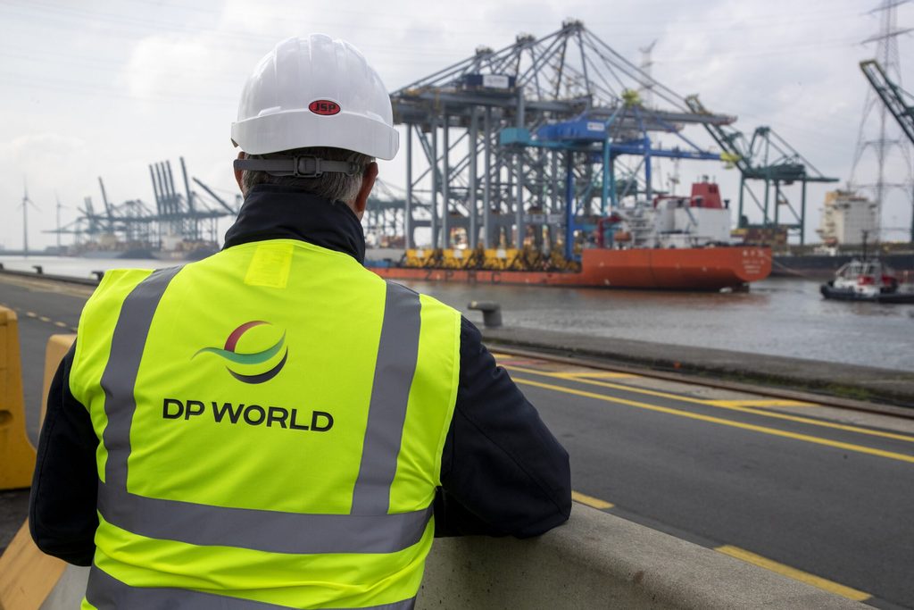 A worker watches new ship-to-shore cranes arrive in Antwerp, Belgium. DP World handles 12% of global trade via its ports and logistics business