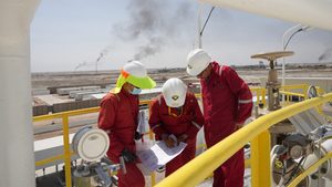 Workers work at Majnoon oil field in Iraq. The country aims to increase output to 7 million barrels per day.