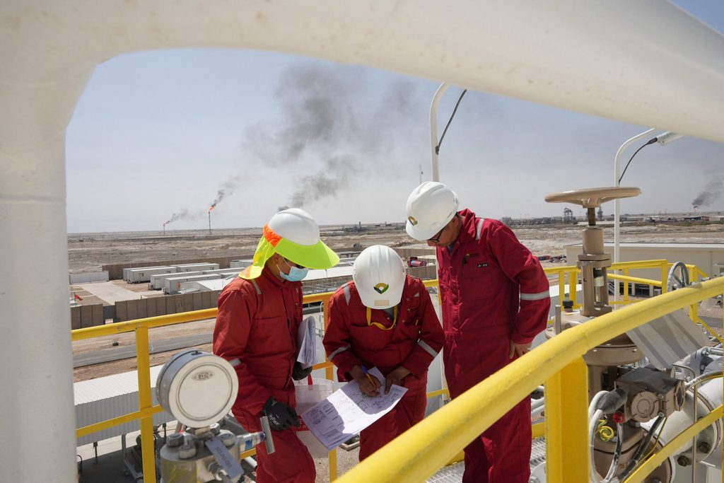 Workers work at Majnoon oil field in Iraq. The country aims to increase output to 7 million barrels per day.