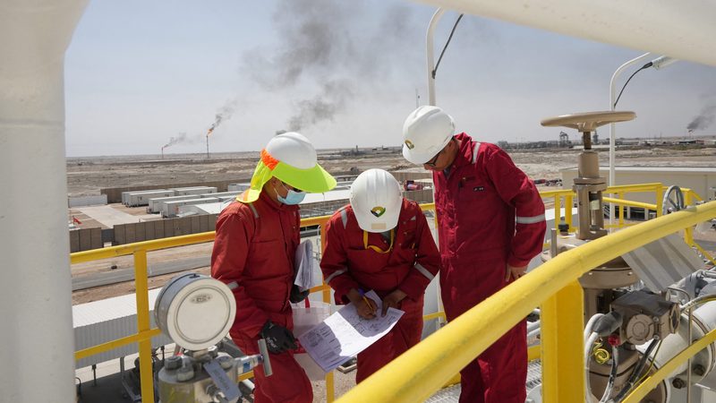 Workers work at Majnoon oil field in Iraq. The country aims to increase output to 7 million barrels per day.