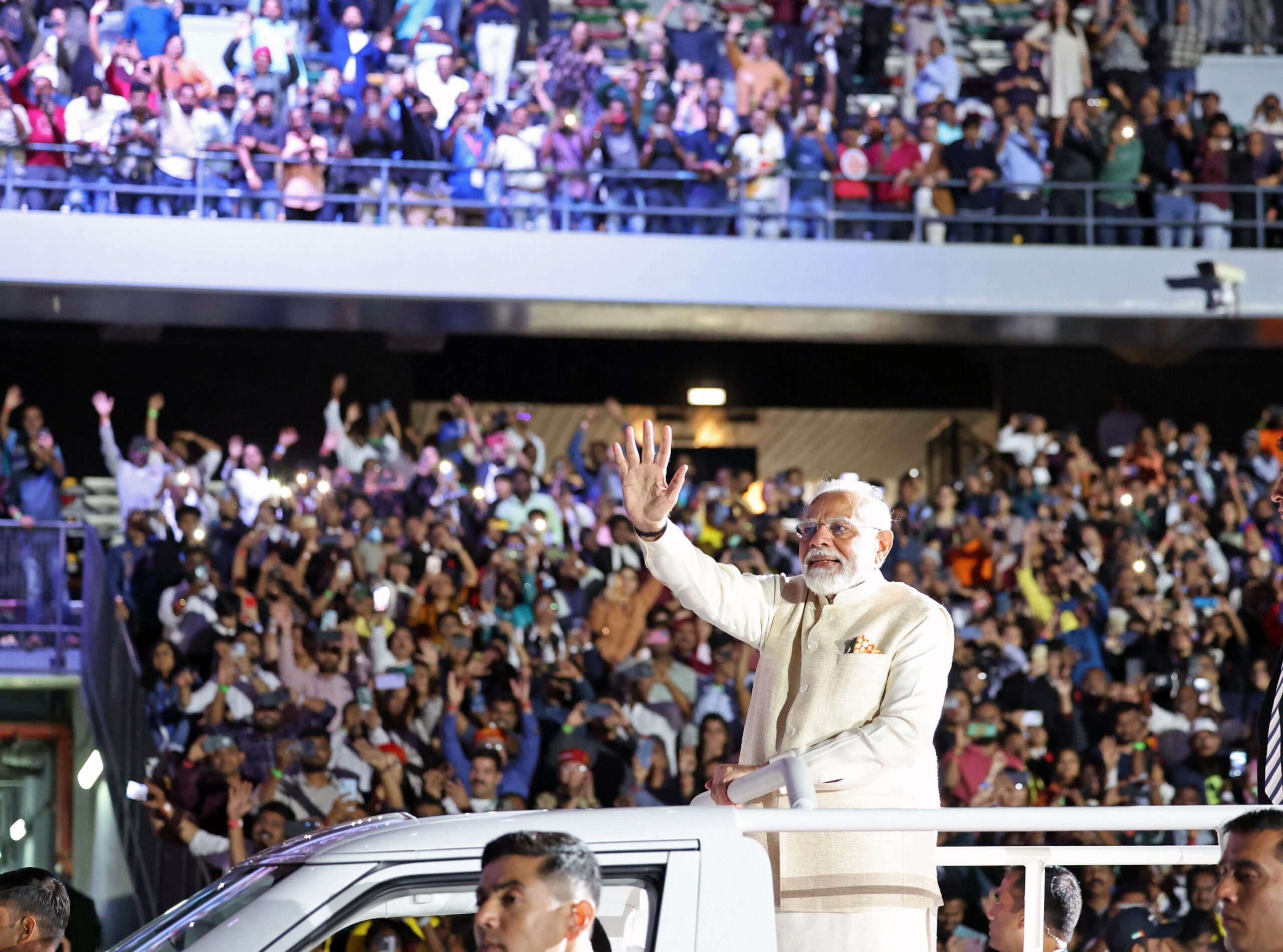 India's PM Narendra Modi waves at supporters gathered at Zayed Sports Stadium in Abu Dhabi on Tuesday