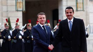 French president Emmanuel Macron greets Qatar's Emir Sheikh Tamim bin Hamad Al Thani in Paris