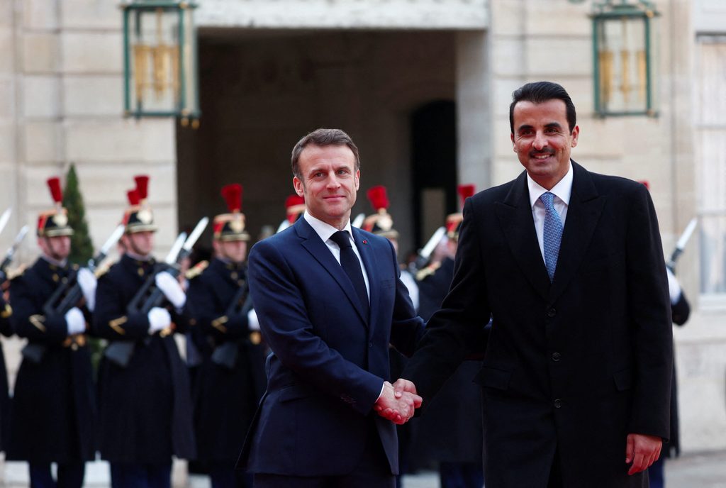 French president Emmanuel Macron greets Qatar's Emir Sheikh Tamim bin Hamad Al Thani in Paris