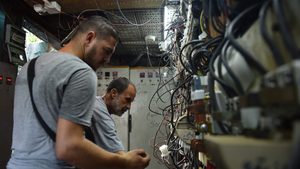 Two men (unrelated to the shooting video) work on an electricity generator in Beirut