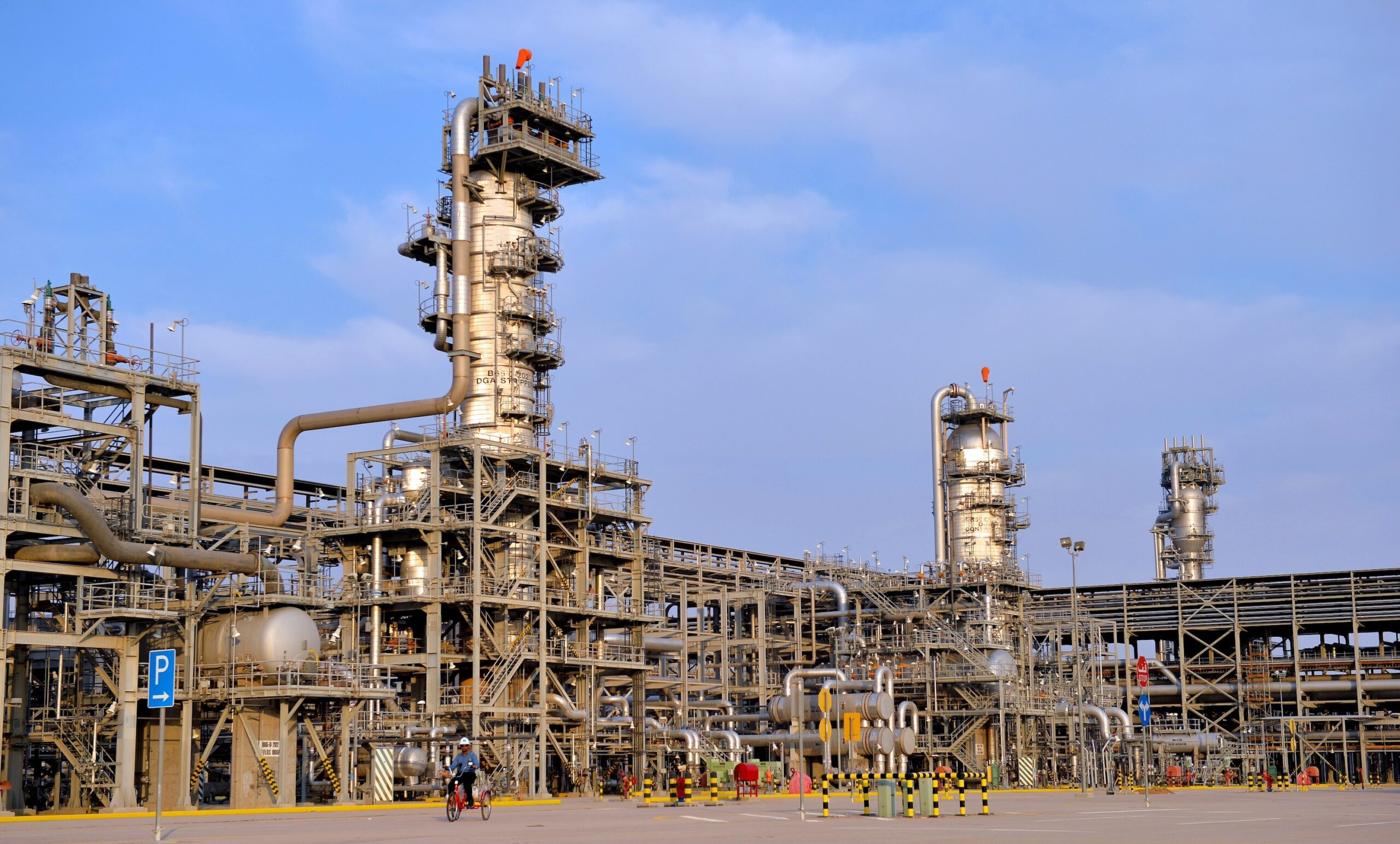 An Aramco worker cycles around the Hawiyah gas plant. The state oil major is planning to expand the facility