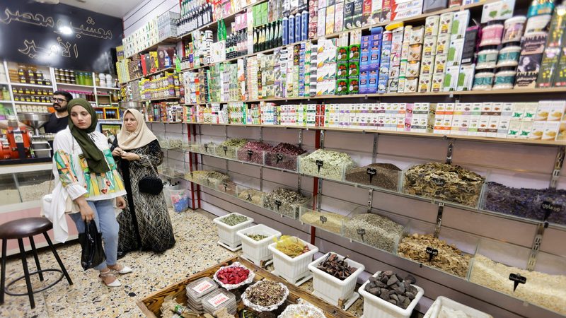 Unable to afford costly medicines, these Iraqi women buy traditional herbal remedies at a shop in Baghdad