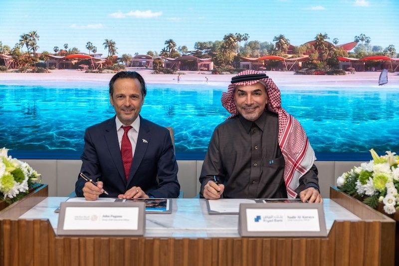 Red Sea Global CEO John Pagano and Riyad Bank CEO Nadir Sami Al-Koraya sign the loan agreement for the Four Seasons Resort