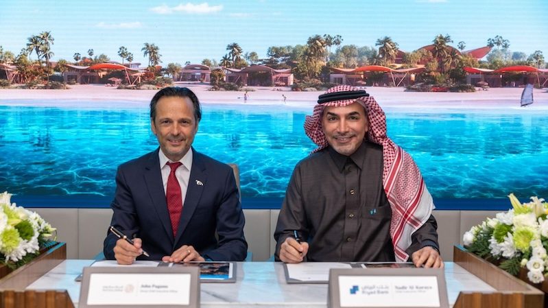 Red Sea Global CEO John Pagano and Riyad Bank CEO Nadir Sami Al-Koraya sign the loan agreement for the Four Seasons Resort