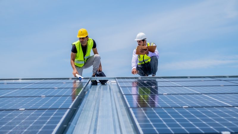 An average of 1.4 GW of new solar capacity will be needed per year until 2037 to meet the increasing demand for electricity in Abu Dhabi engineers solar panels hard hats solar power