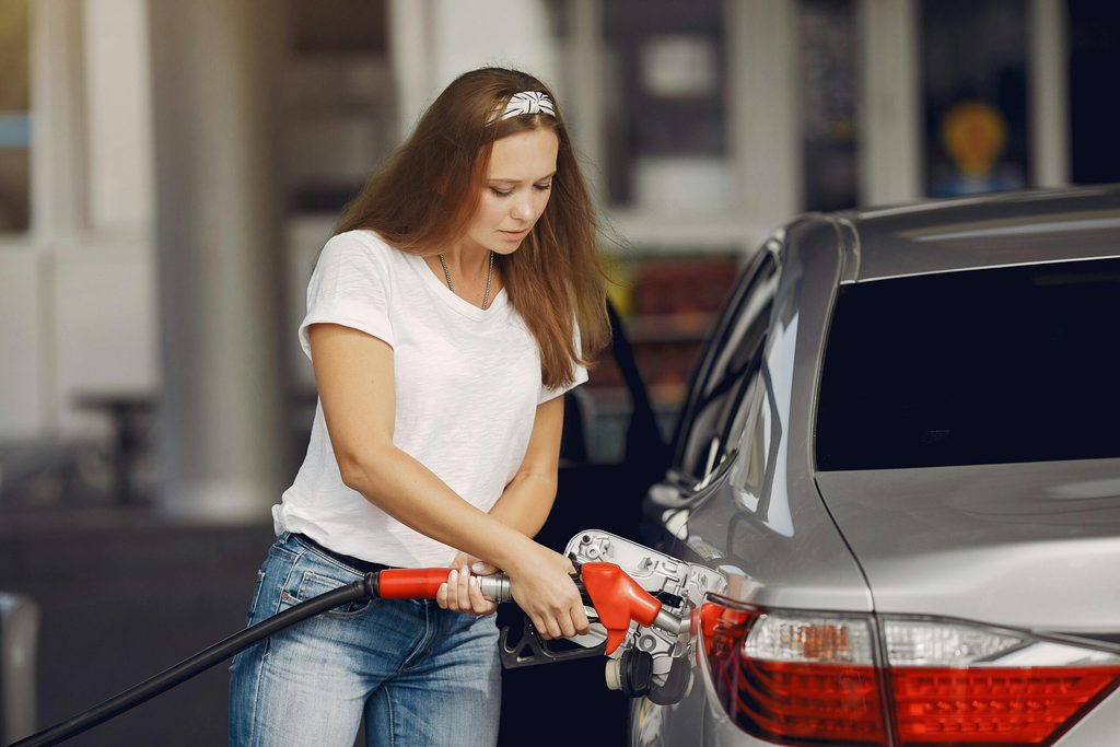 A woman at petrol pump. US politicians who label Opec a price-fixing cartel may have to rethink