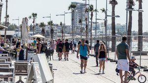 Tourists walk on the road next to the beach in Paphos, Cyprus. Gulf funds are 'looking at all of Cyprus', particularly in real estate