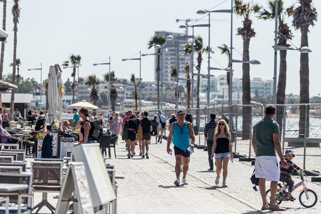 Tourists walk on the road next to the beach in Paphos, Cyprus. Gulf funds are 'looking at all of Cyprus', particularly in real estate