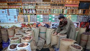 A man waits for customers at his dates shop in Cairo. The Egyptian government says it will increase tax revenues by 30 percent 'without burdening citizens'