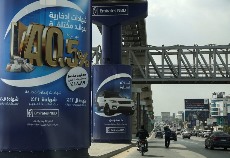 Ads for Emirates NBD investments near a branch of the bank in Cairo