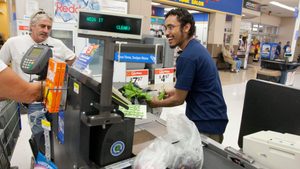 A cashier rings up products at a Walmart store in San Marcos, Texas. Gulf wealth funds invest in US household names such as Walmart and Starbucks