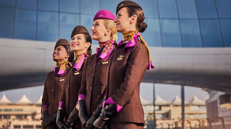 Etihad crew catered to 14 million passengers in 2023, resulting in a 31 percent rise in passenger revenue to AED16.6 billion women cabin crew Etihad airline smiling