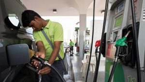 A worker at a petrol station in Kuwait City. Kuwait is the GCC nation most economically dependent on hydrocarbons, according to the EDI