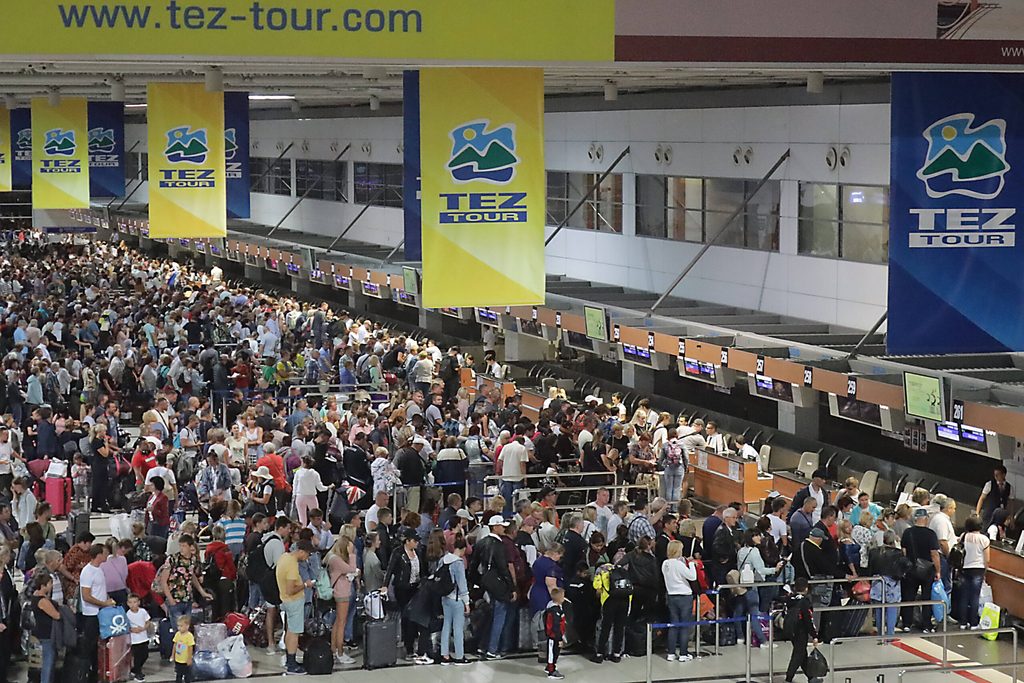 Passengers queue to check in at Antalya airport, Turkey's second busiest