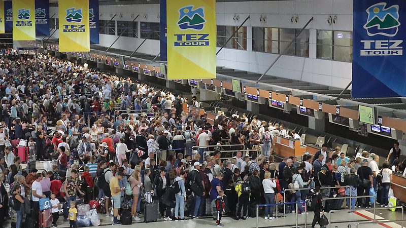 Passengers queue to check in at Antalya airport, Turkey's second busiest