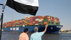A container vessel passes through the Suez Canal. Global supply chain volatility is falling, according to the latest data