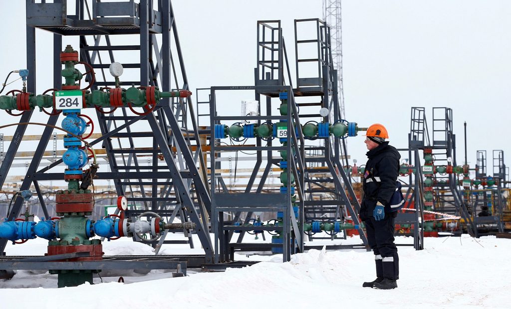 An employee inspects a well head in the Yarakta oil field in Siberia. Russia's oil output has been hit by Ukrainian drone attacks on facilities