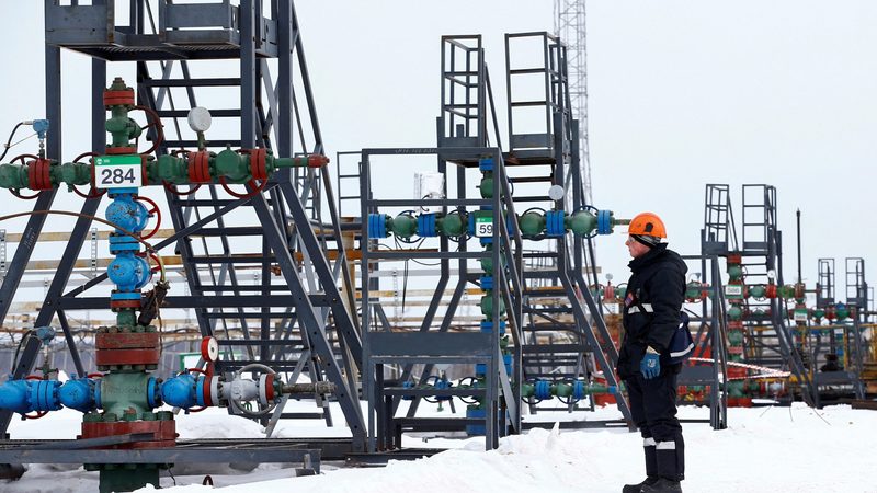 An employee inspects a well head in the Yarakta oil field in Siberia. Russia's oil output has been hit by Ukrainian drone attacks on facilities