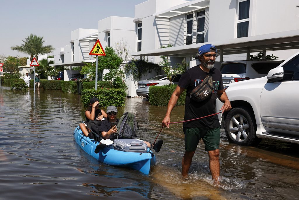 Dubai residents receive help from volunteers as they evacuate their flooded homes