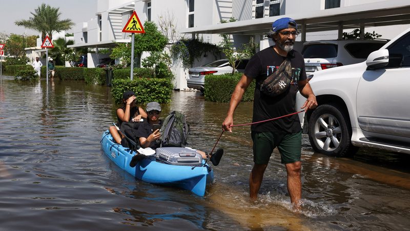 Dubai residents receive help from volunteers as they evacuate their flooded homes