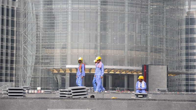 Construction workers in Dubai. The sector is suffering less from payment delays that affect other Gulf states