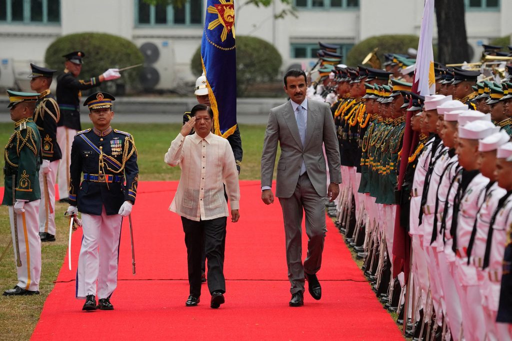 Philippine President Ferdinand Marcos Jr., walks with Qatar's Emir Sheikh Tamim Bin Hamad Al Thani during arrival honors at the Malacanang Presidential palace in Manila, Philippines, April 22, 2024. Aaron Favila/Pool via REUTERS