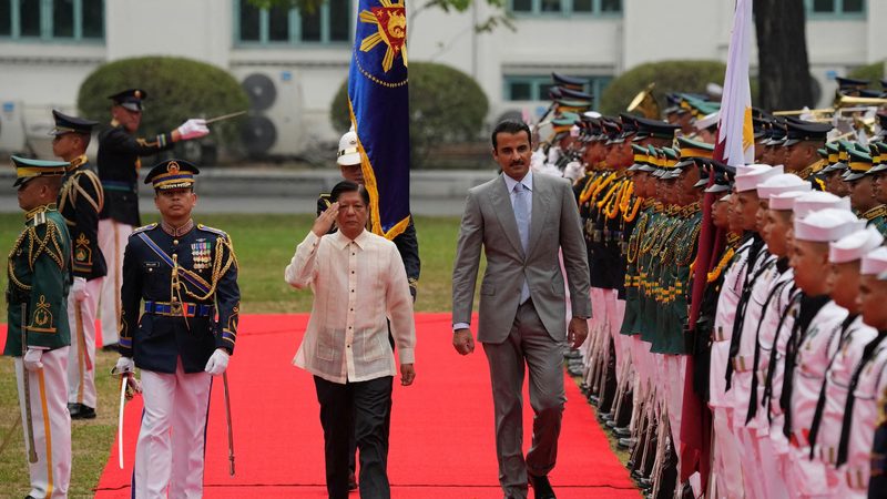 Philippine President Ferdinand Marcos Jr., walks with Qatar's Emir Sheikh Tamim Bin Hamad Al Thani during arrival honors at the Malacanang Presidential palace in Manila, Philippines, April 22, 2024. Aaron Favila/Pool via REUTERS