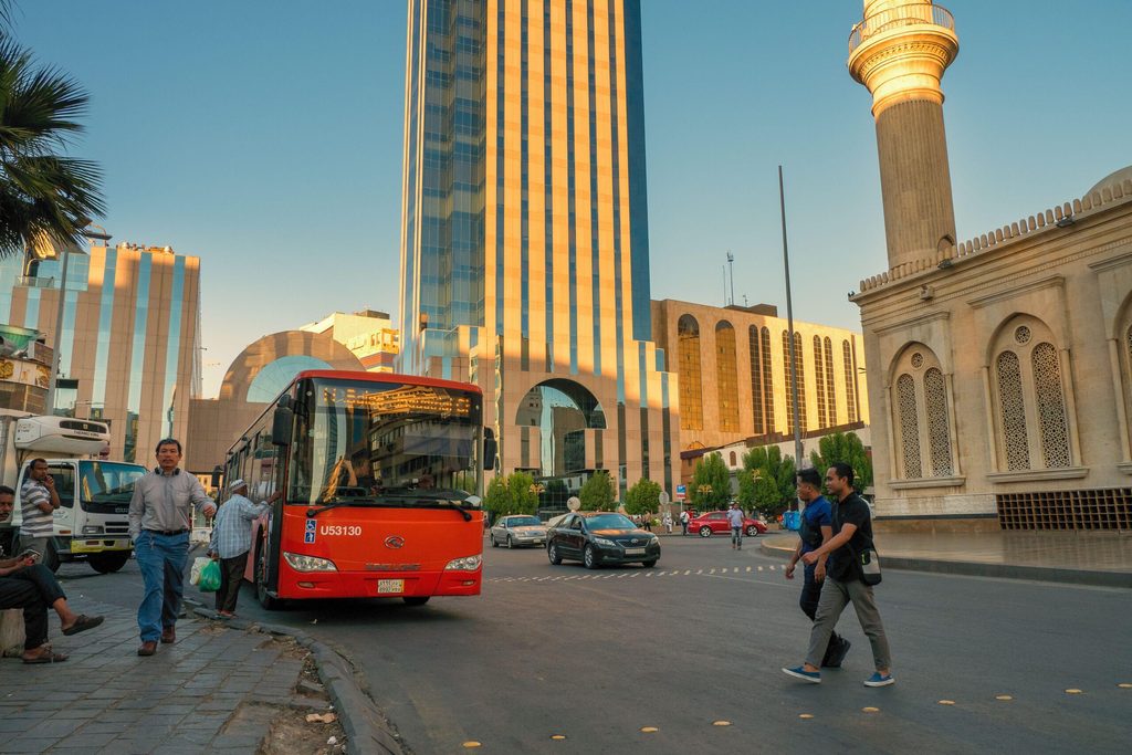 Passengers board a bus in Riyadh. Saudi transport costs fell 1.8 percent year on year