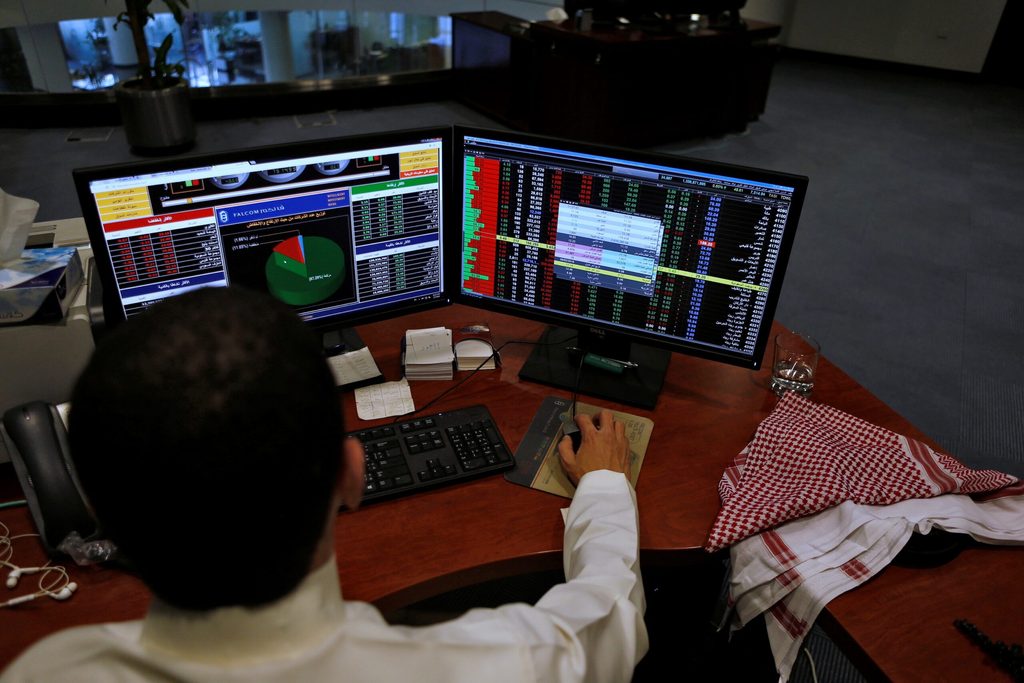 A Saudi trader observes the stock market on monitors at Falcom stock exchange agency in Riyadh, Saudi Arabia February 7, 2018. REUTERS/Faisal Al Nasser