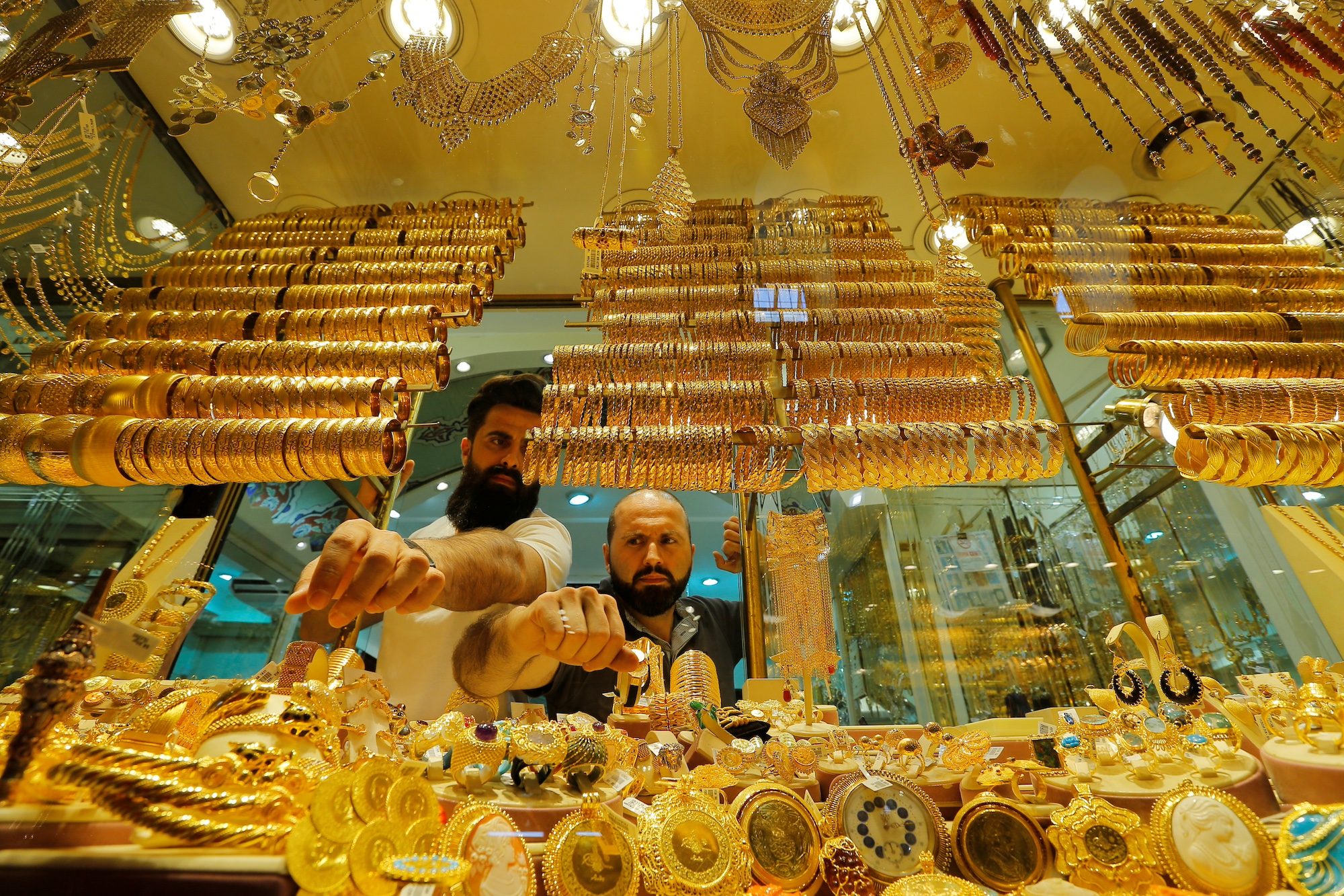 Goldsmiths arrange products in a jewellery store in Istanbul. Demand for gold is rising sharply in Turkey