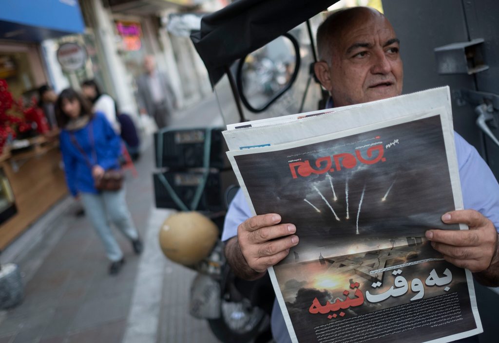 Iran Israel oil man reading newspaper
