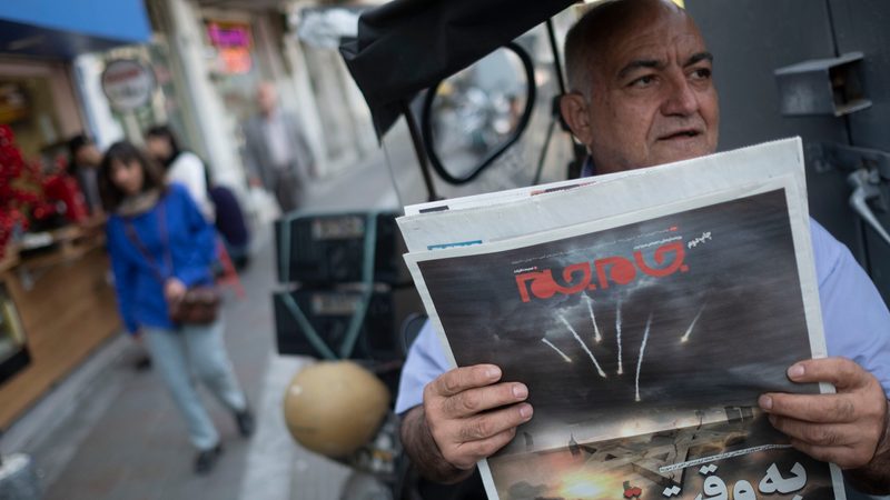 Iran Israel oil man reading newspaper