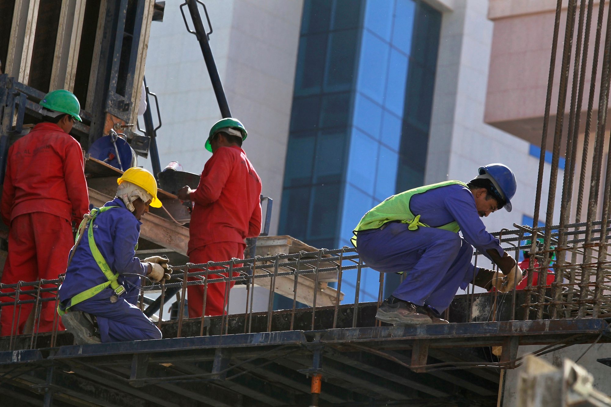 Foreign labourers work at the construction site of a building in Riyadh Foreign workers on a building site in Riyadh; thousands of migrants who have the right to work in Saudi Arabia could have their work permit fees covered for four years from the date of recognition