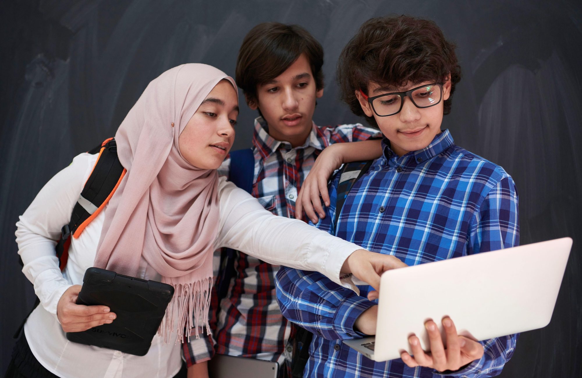 Teenage students use a laptop and tablet. One cybersecurity expert said pupils' personal devices could increase the risk of data breaches