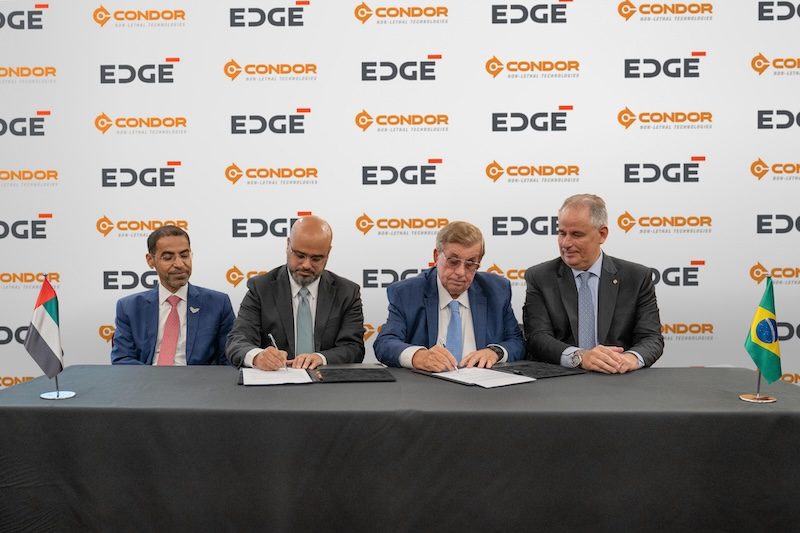 Executives from the UAE's Edge Group and Brazil's Condor sign the stake acquisition deal
