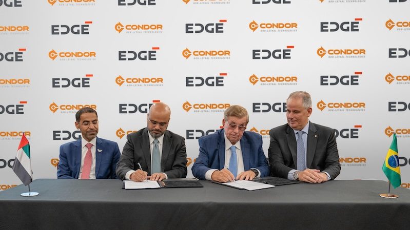 Executives from the UAE's Edge Group and Brazil's Condor sign the stake acquisition deal
