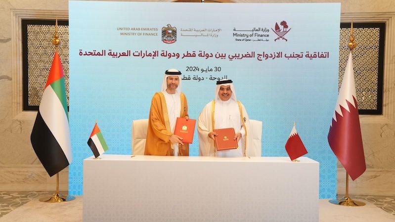 Mohamed Hadi Al Hussaini, UAE minister of state for financial affairs, and Qatari finance minister Ahmed Al Kuwari sign the tax agreement