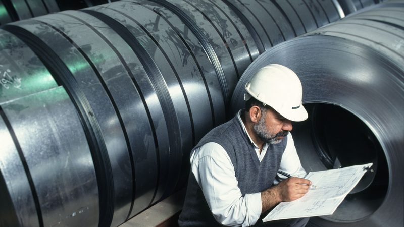 Clothing, Hardhat, Helmet A worker makes notes at a Saudi Arabian steel factory; the industrial production index fell from 114 points in March 2023 to 104 in March 2024