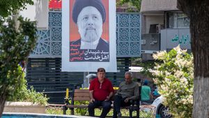 Two men sit beneath a tribute to President Ebrahim Raisi in Tehran; Iran has said it will increase exports but analysts speculate that the announcement my be politically motivated