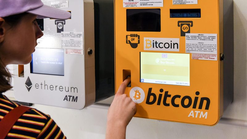 A woman using a Bitcoin ATM in Hong Kong. The Mena region accounts for 7% of global cryptocurrency volumes