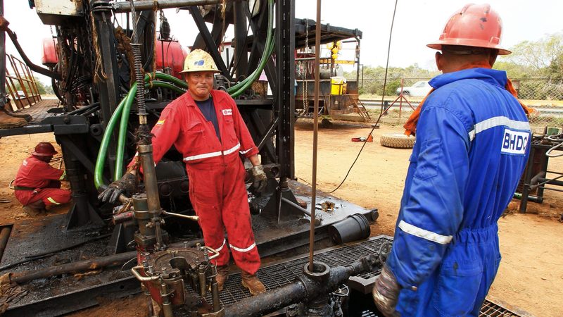 Oil workers in Venezuela, a founder member of Opec. The IEA predicts slower demand growth