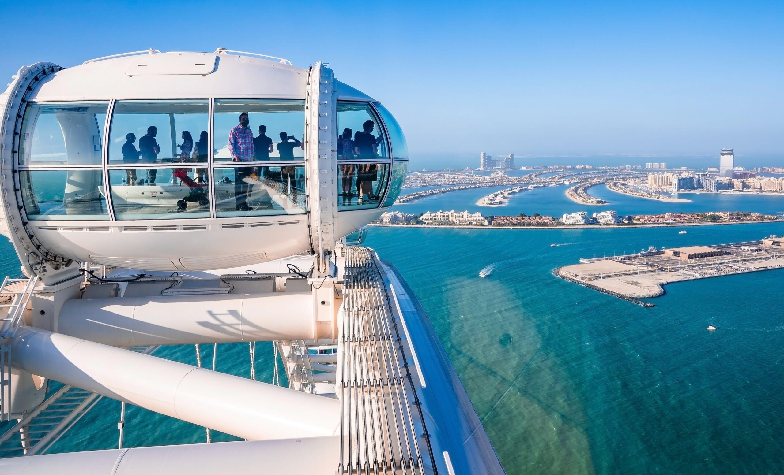 People on the Ain Dubai ferris wheel on Bluewaters Island admire the view of Palm Jumeirah. Both locations were popular with Russian property buyers