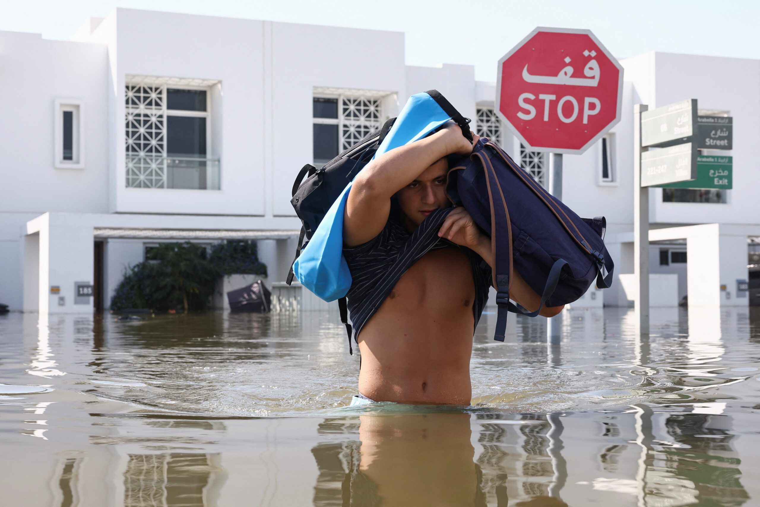 A man moves his belongings from a flooded residential complex in Dubai. It has been reported that only 15% of UAE residents have flood insurance