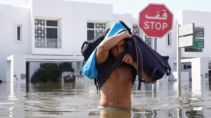 A man moves his belongings from a flooded residential complex in Dubai. It has been reported that only 15% of UAE residents have flood insurance