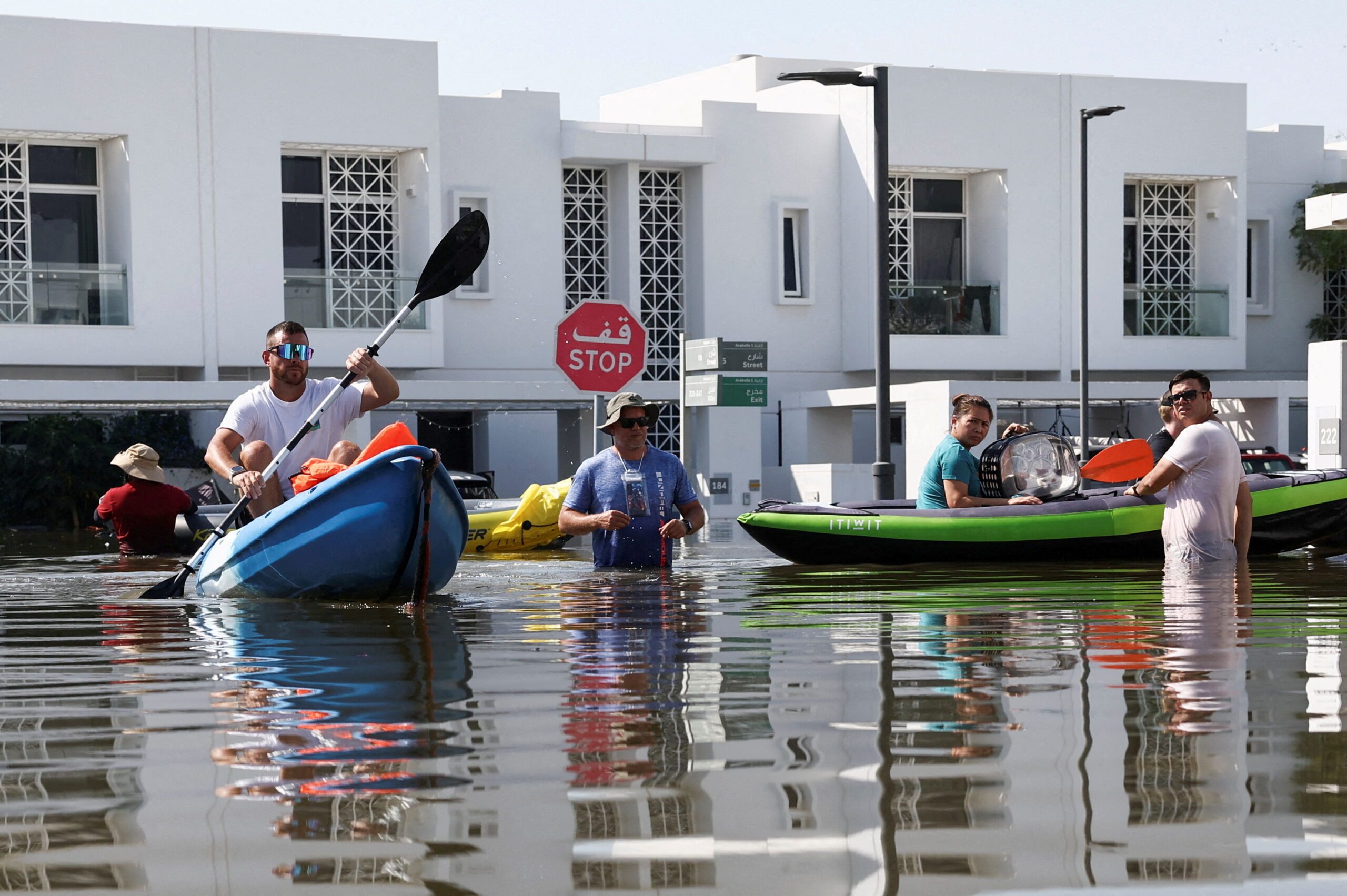 Residents use kayaks to evacuate their flooded residential complex in Dubai following the April storm