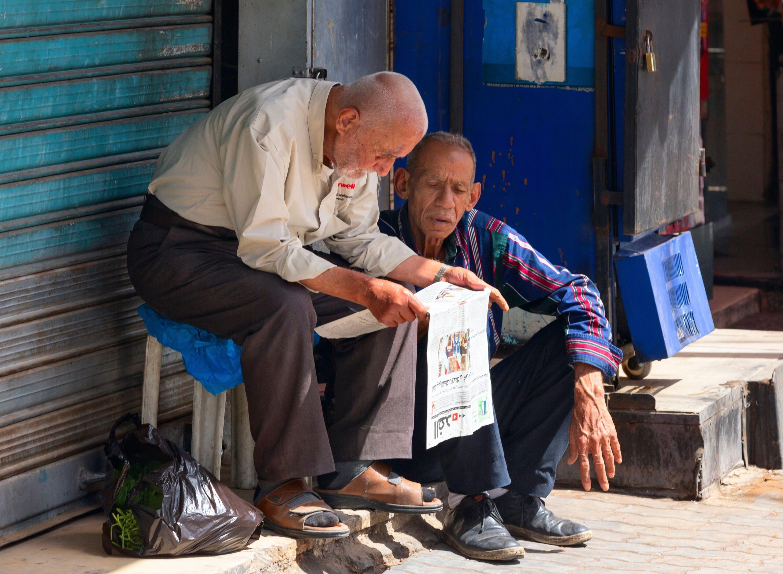 Men in Amman, Jordan reading a newspaper. Publications are under financial pressure in the absence of a big subsidising owner